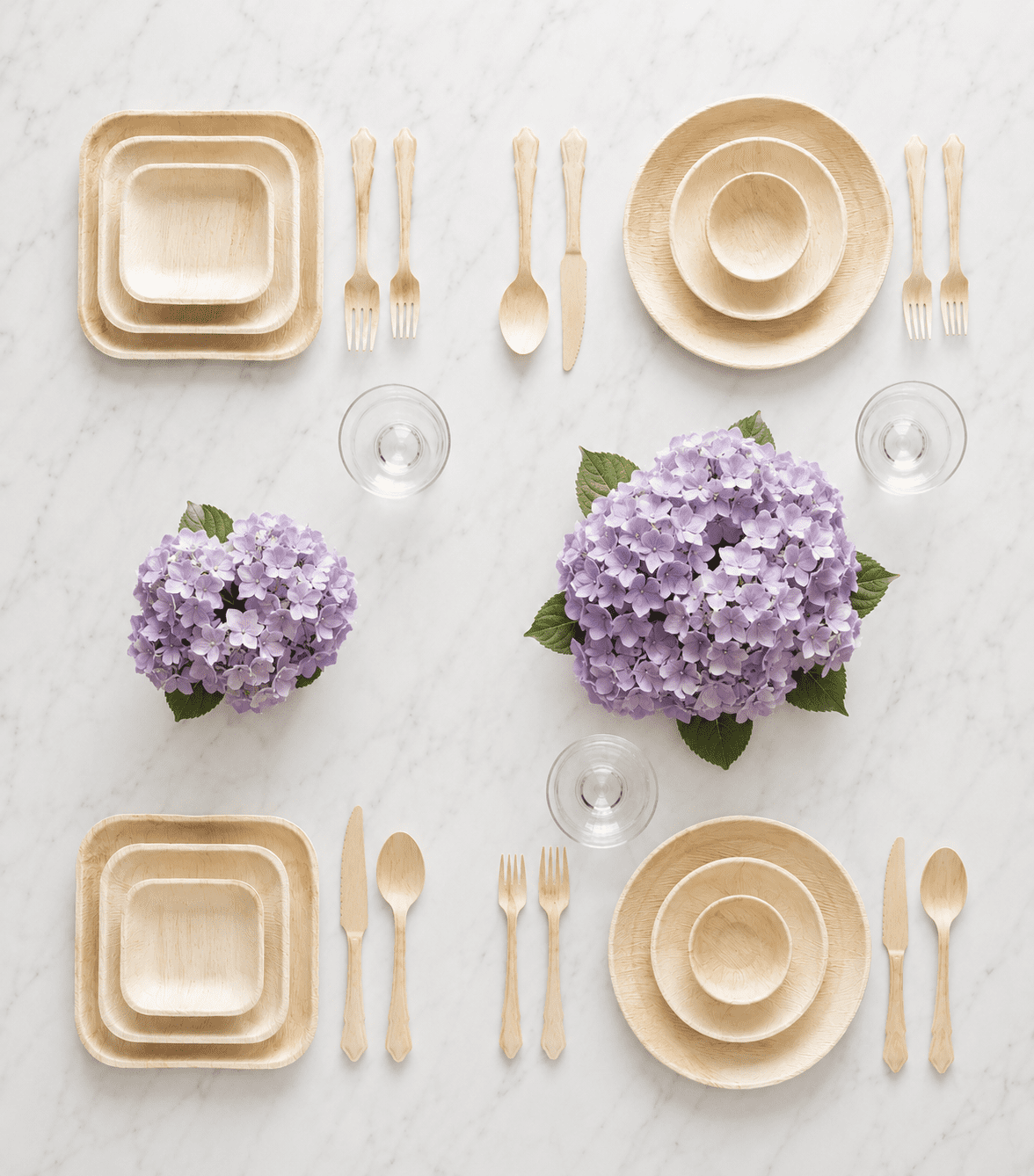 Palm leaf plates private label hero — elegant tabletop styling with square and round palm leaf plates, wooden cutlery, glasses, and hydrangea centerpieces, manufactured for B2B importers by Ecodyne Tableware OEM service
