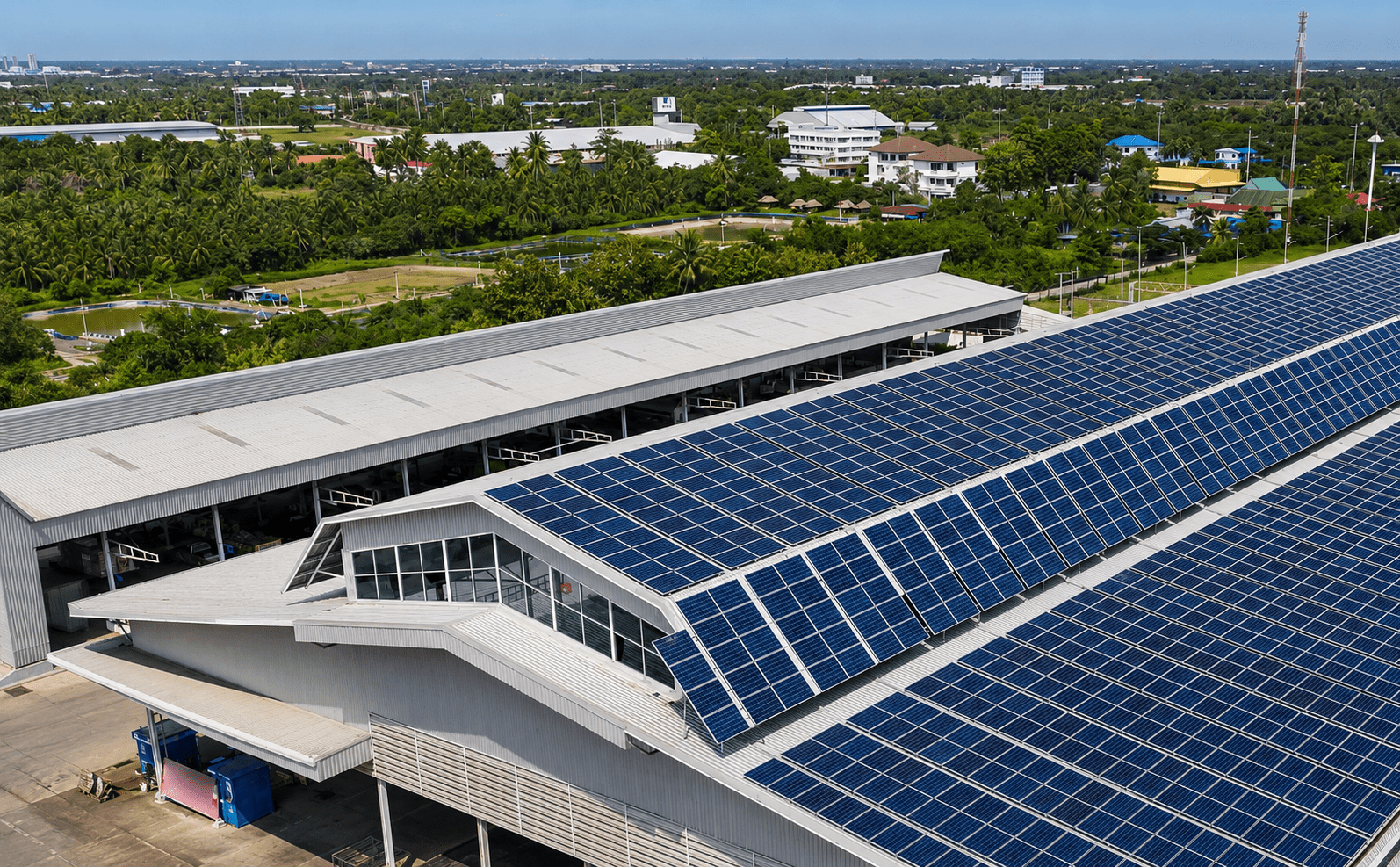 Solar-powered palm leaf plate manufacturing — rooftop solar panel array on Ecodyne factory roof in Karnataka India